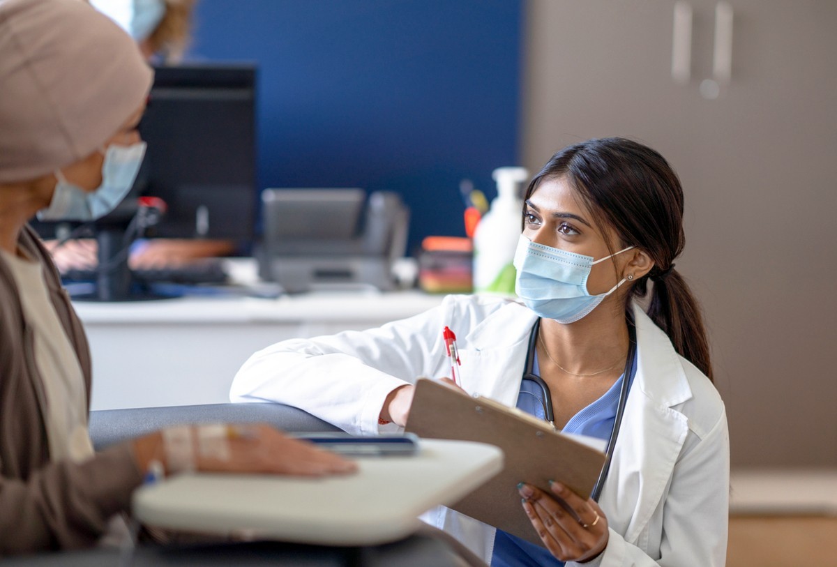 A health professional talking with a patient.
