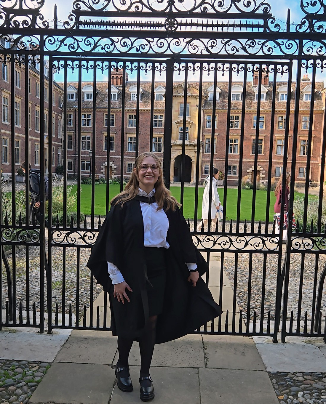 Kate Bucek of UAlbany stands in front of Cambridge University after receiving her graduate degree.