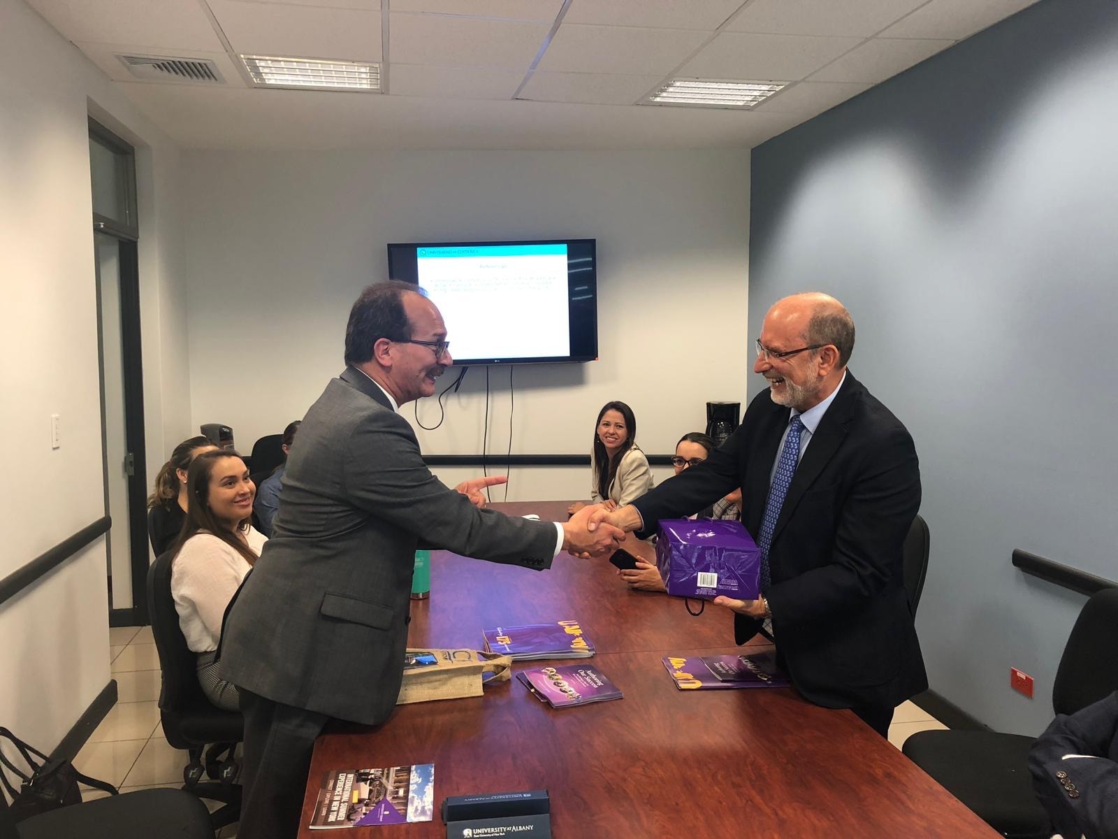 President Rodriguez shakes hands with an international partner while visiting Costa Rica.