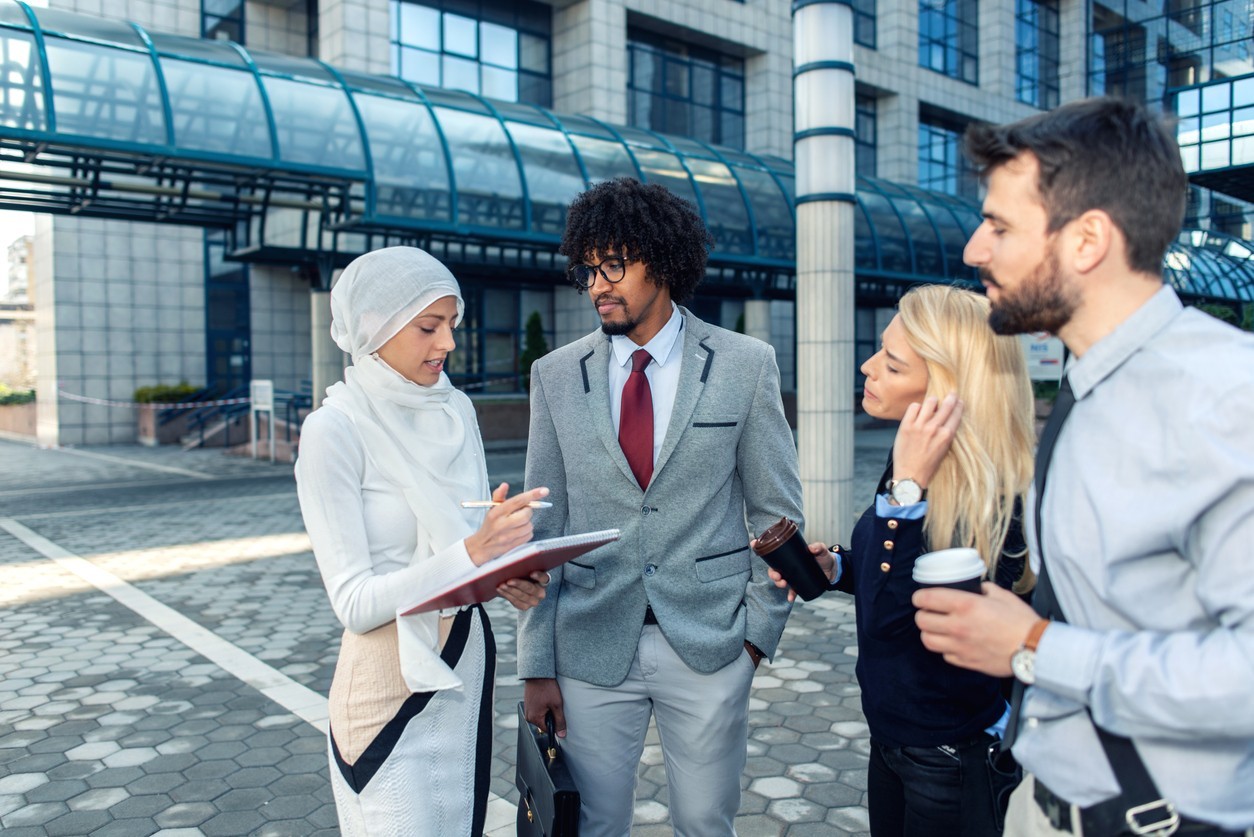 Group of young professionals consulting in a city