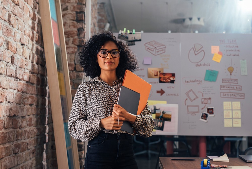 Young professional standing in front of a white board