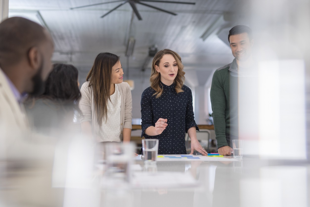 Group of professionals having a discussion around a conference table