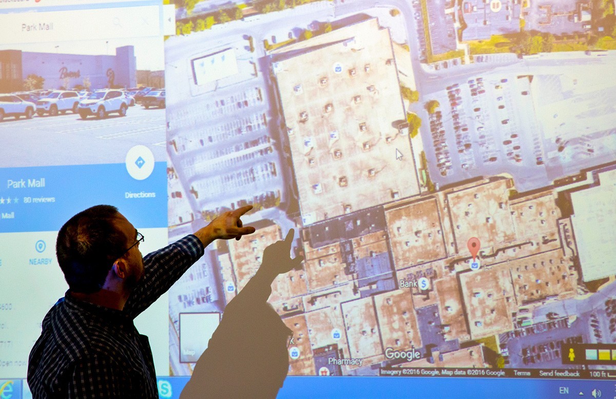 A student studies a Google satellite view map during terrorist planning training