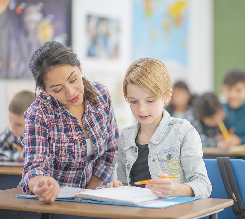 Teacher helping student in class