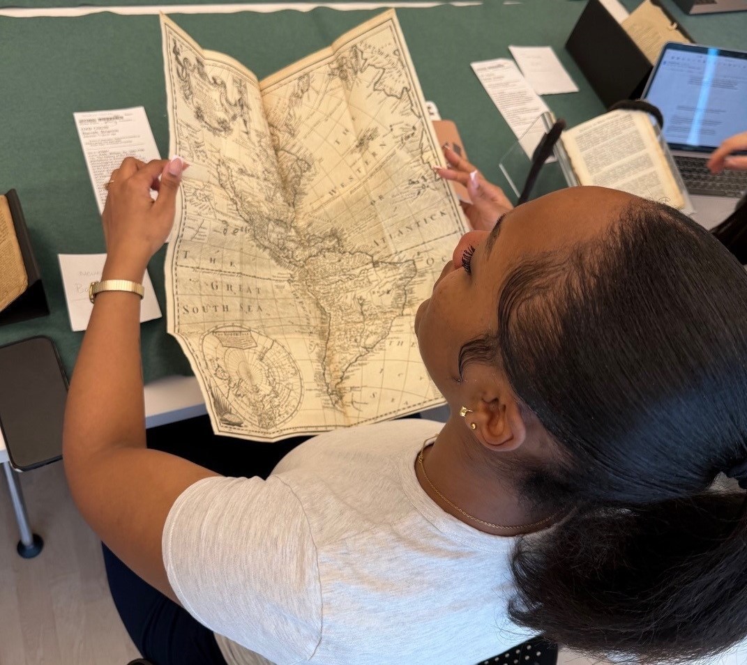 A student looking at an antiquarian map.