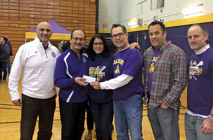 A $50,000 check for the McGovern Scholarship presented at the Big Purple Growl