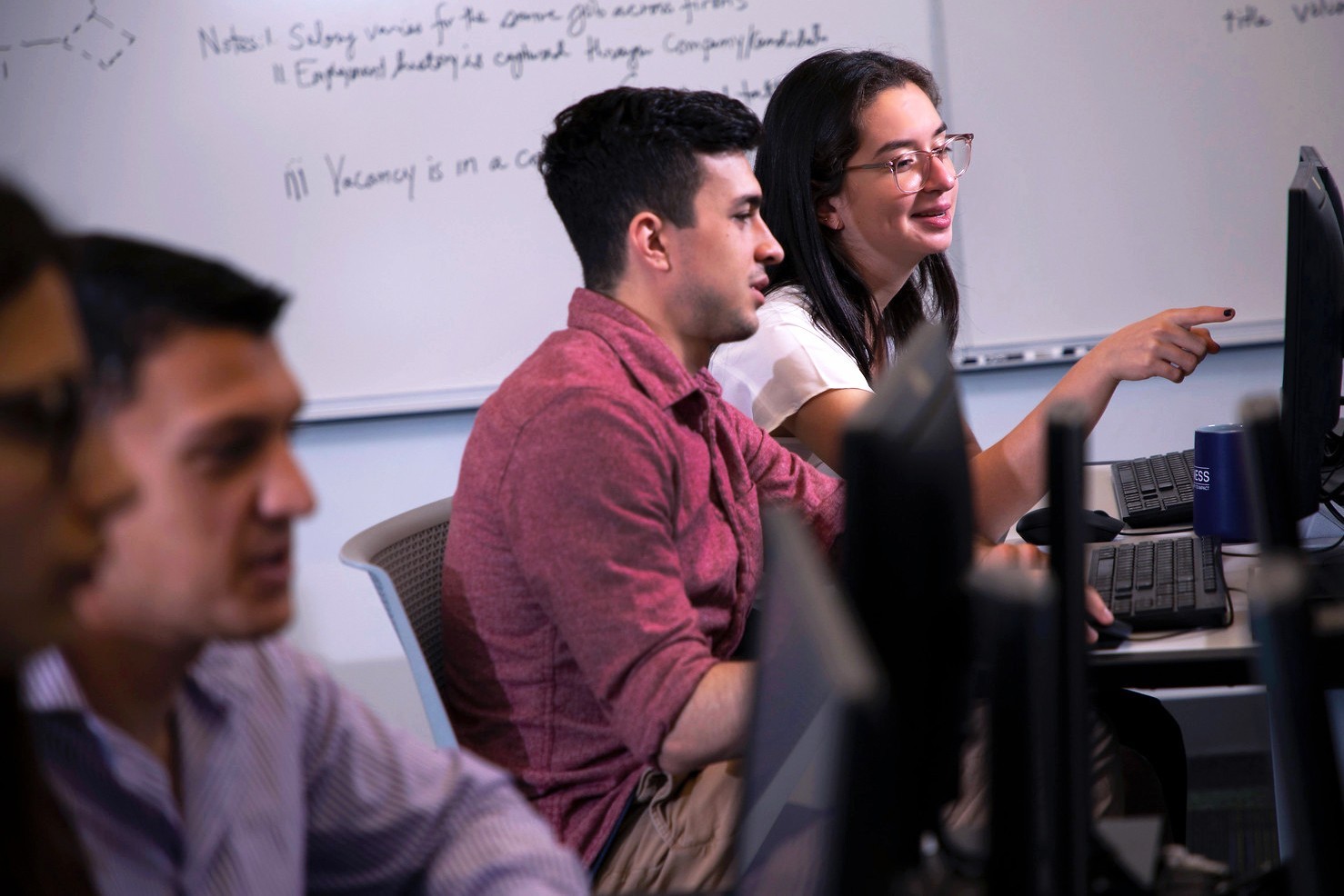 Digital Forensics and Cybersecurity students working in a computer lab