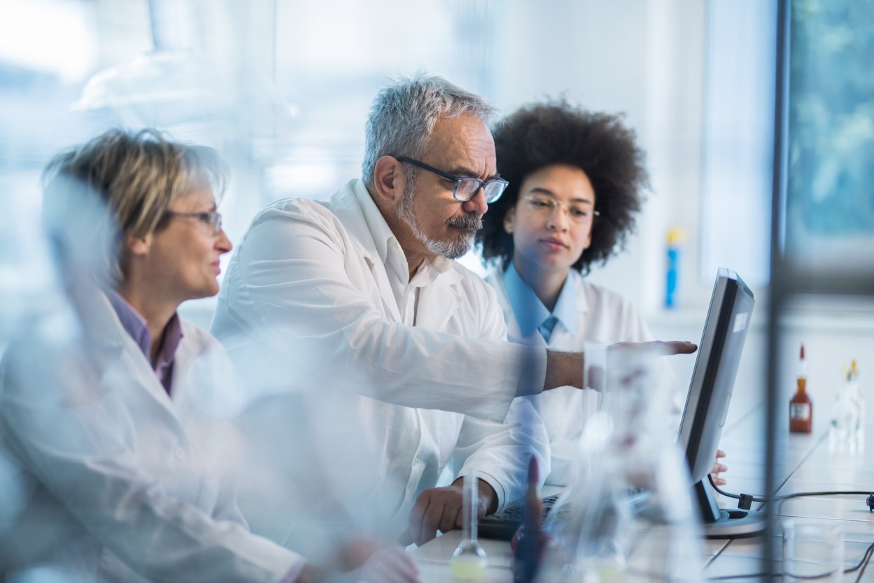 Team of researchers working on a computer in a laboratory