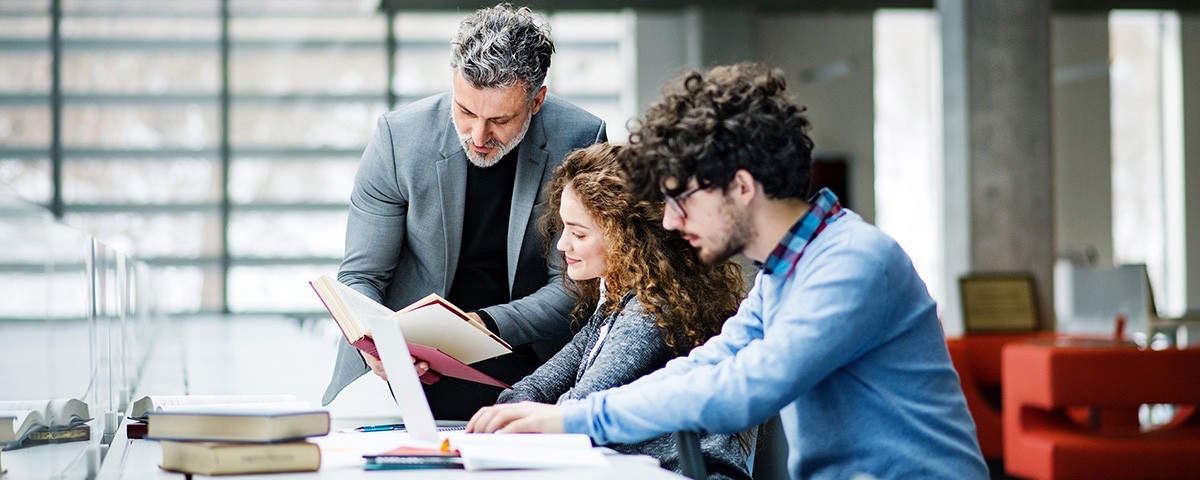 Students with their professor in a library.