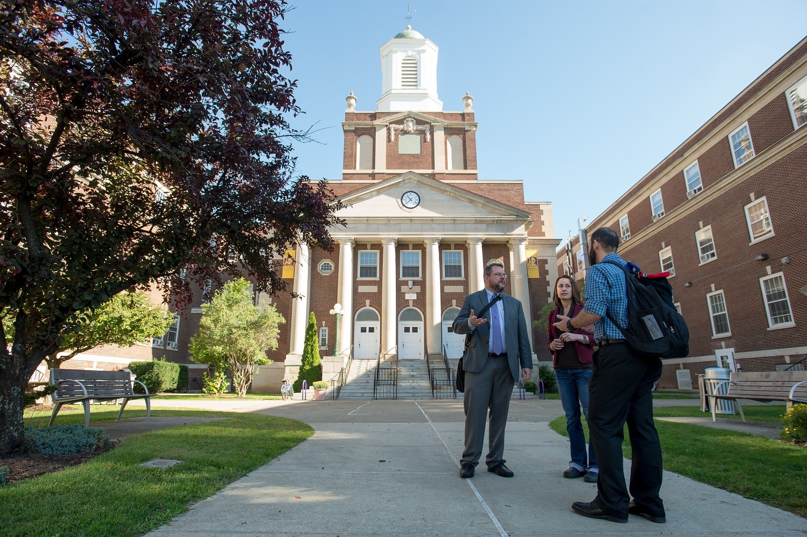 Dean Rethemeyer speaking with two students outside on the UAlbany Downtown Campus