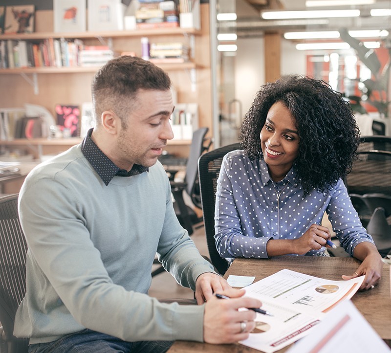 Two adults looking at research