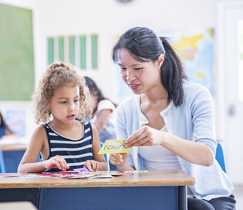 Teacher and student working with flashcards