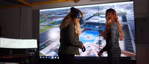 xCITE Lab director Kara Sulia and student in front of screen