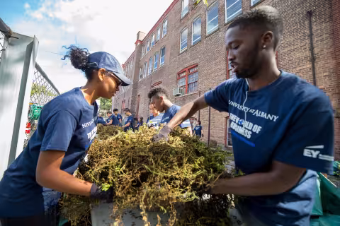 World of business student participate in living-learning community service day with yard-work