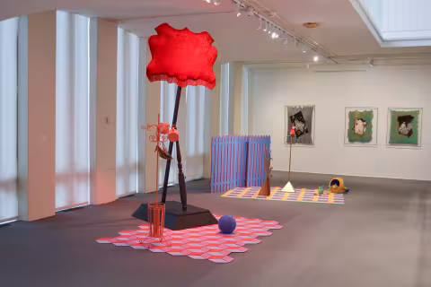 a red billow on a pole with a coat rack and other displays