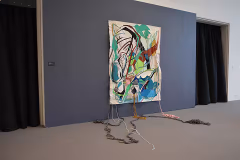 a painting on white cloth with yarn and string coming off of it