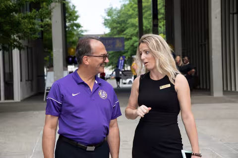 Ema Buco, Assistant Director for Residential Life, speaks with the UAlbany President outside Indigenous Quad on a move-in day