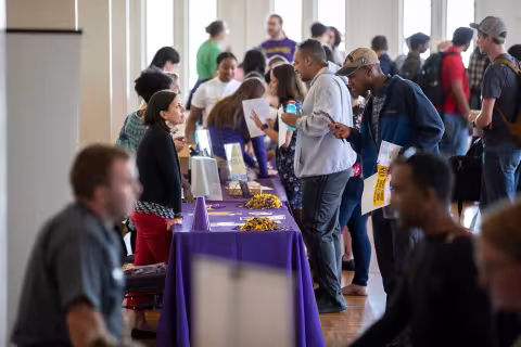 Students engaging in conversation at Graduate Student Resource Fair