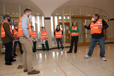 Volunteers standing in a circle being trained before the vaccine POD opened.