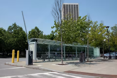 Colonial Quad is visible behind a bus stop on campus
