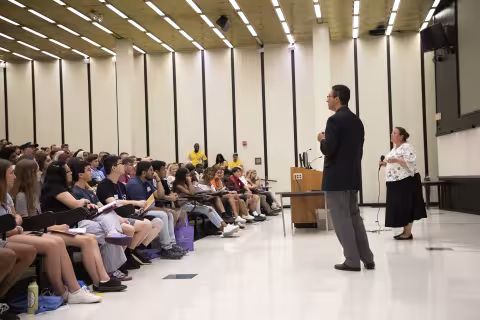 University Vice Presidents talking to students at orientation.