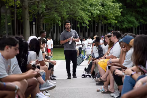 Student worker speaking to other students during move in.