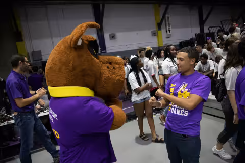 Student dancing with Damien at Convocation.
