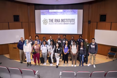 NIIMBL eXperience students pose for a group photo in the RNA Institute auditorium