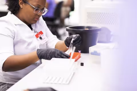 Student uses a pipette during a DNA extraction experiment. 
