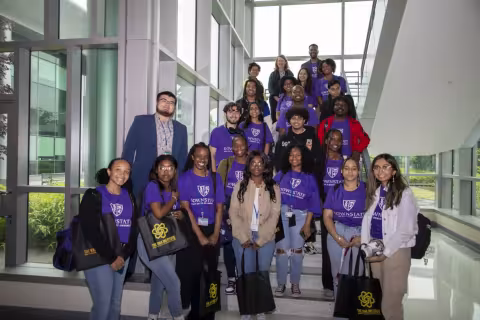 The SPRINTER students gather on a sunlit staircase in the RNA Institute with Annis Golden and Elizabeth Vásquez.