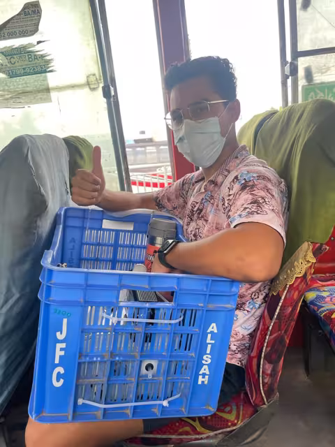 Santosh Jagan of Md. Aynul Bari's summer research team on a bus in Dhaka, Bangladesh.