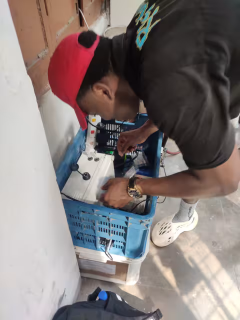 Marco Eugene looks over equipment for monitoring air quality in Dhaka, Bengladesh.