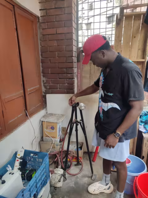 Marco Eugene looks over equipment for monitoring air quality in Dhaka.