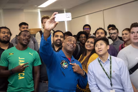 Former NASA Astronaut Leland Melvin takes a photo with students at the College of Nanotechnology, Science, and Engineering.
