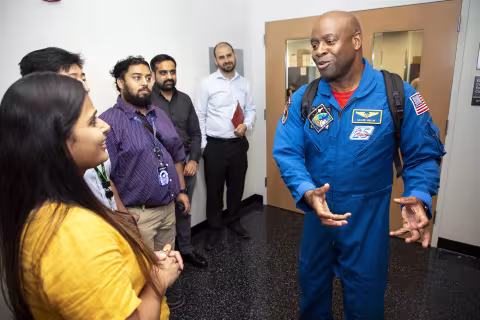 Former NASA Astronaut Leland Melvin with students at the College of Nanotechnology, Science, and Engineering.