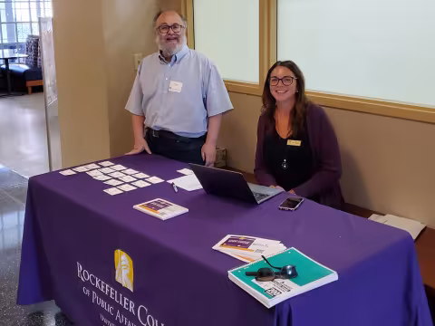 Victor Asal and Renee Wallingford from Rockefeller College greet visitors during Research and Entrepreneurship Week