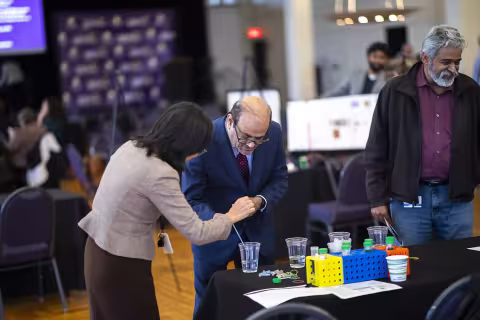 Vice President for Research and Economic Development Thenkurussi (Kesh) Kesavadas explores the poster presentations during Research and Entrepreneurship Week in the Campus Center Ballroom.