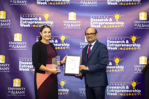 Associate Professor Kristin L. Corbosiero with Vice President for Research and Economic Development Thenkurussi (Kesh) Kesavadas.