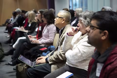 Row of seated people gathered for the ISHE launch event in UAlbany's ETEC building.