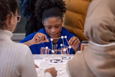 A woman takes part in a table-top experiment at UAlbany's STEM & Nanotechnology Family Day at ETEC.