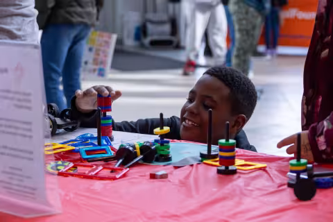 A young boy conducts a table-top experiment at UAlbany's STEM & Nanotechnology Family Day at NY CREATES' Albany NanoTech Complex.
