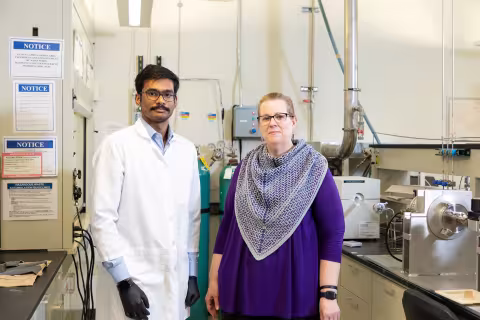 Nanoscale PhD Student Sri Saravana Konganapuram Narasimma Bharathi and Professor Kathleen Dunn stand smiling inside Professor Dunn's lab.