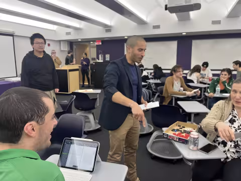 Faculty and staff from UAlbany's Department of Mathematics and Statstics celebrates Pi Day on March 14 with pizza.