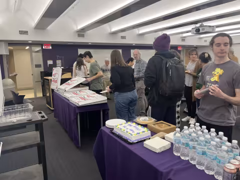 Faculty and staff from UAlbany's Department of Mathematics and Statstics celebrates Pi Day on March 14 with pizza.