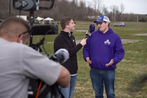 UAlbany senior Evan Belkin interviews with WNYT's Reid Kisselback at Fort Drum.