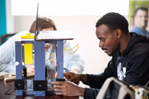 Students Jacob Bruno and Shak Williams work on their mail sorting device at the CDS mail facility in Colonie NY