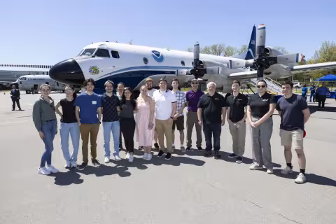 UAlbany students, faculty and staff stand in front of the NOAA Hurricane Hunter.