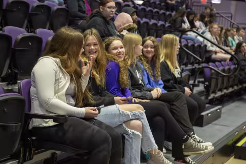 A group of middle school students listen while visiting Showcase Day 2024 at Broadview Center.