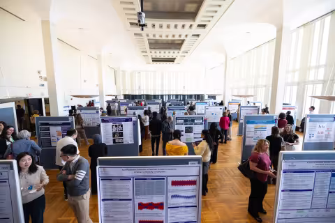 The Campus Center ballroom at UAlbany is filled with poster presentations and students and visitors during Showcase Day 2024.