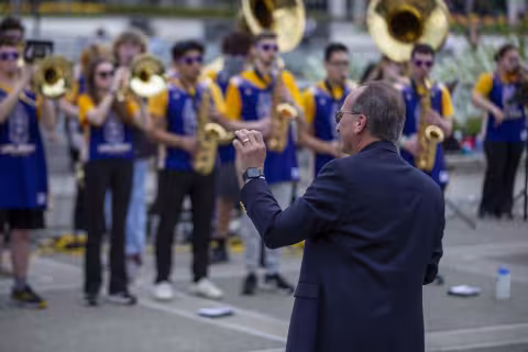 UAlbany President Havidan Rodriguez leads the UAlbany marching band as guest conductor during Showcase Day 2024 on the Academic Podium at UAlbany.